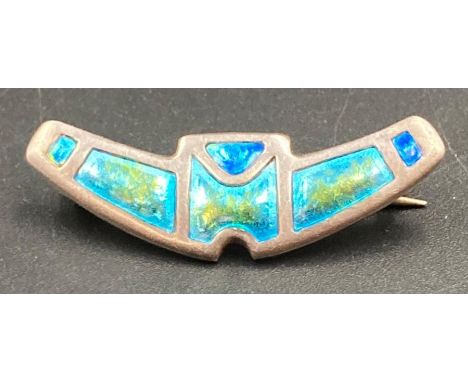 A silver and enamel brooch by Charles Horner