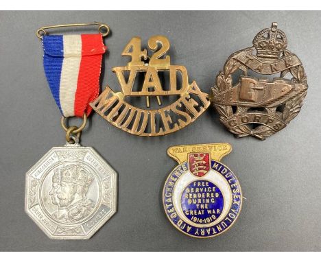 A selection of military medals, badges and insignia to include a WWI Tank Corp, 1935 Silver Jubilee medallion, 42 VAD Middles
