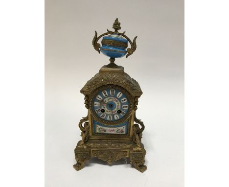 A gilt metal eight day mantel clock