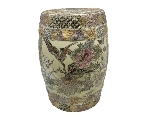 Oriental pierced ceramic garden seat, heavily decorated with birds upon blossoming branches and butterflies within panelled g