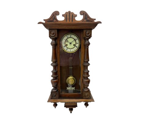 Small Spring driven German wall clock in a mahogany case with turned columns and pendants, with a fully glazed door and gridi