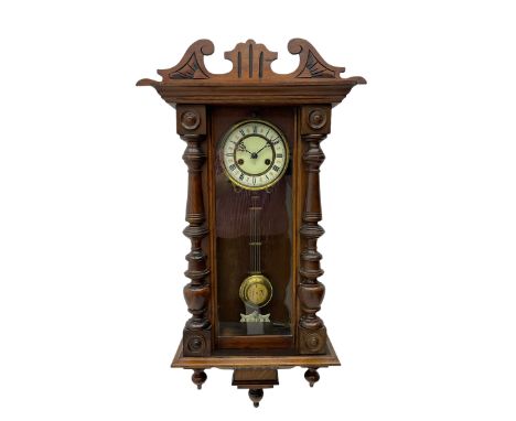 Small Spring driven German wall clock in a mahogany case with turned columns and pendants, with a fully glazed door and gridi