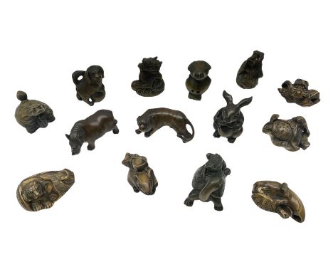 Group of fourteen Netsuke, to include two examples modelled as tortoise with a frog upon its shell, rhino, tiger, bird etc, s