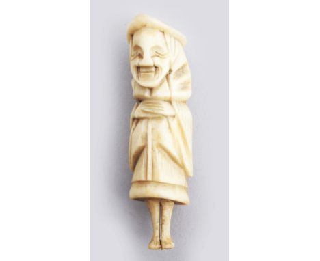 A JAPANESE MEIJI PERIOD STAG ANTLER NETSUKE OF A STANDING DUTCHMAN, 2.5in high.