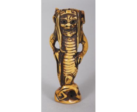 A SIGNED JAPANESE MEIJI PERIOD STAINED IVORY NETSUKE OF AN ONI MERMAN, the base with an engraved signature, 2.4in high.