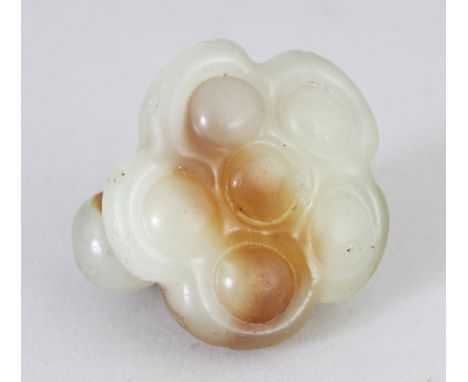 A 19TH/20TH CENTURY CHINESE CELADON JADE CARVING OF A LOTUS POD, the stone with russet inclusions, 1.3in wide &amp; 1.1in hig