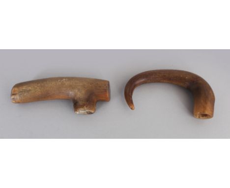 TWO EARLY 20TH CENTURY CARVED HORN WALKING STICK HANDLES, possibly Rhinoceros horn, 4.4in &amp; 4.8in wide. (2)