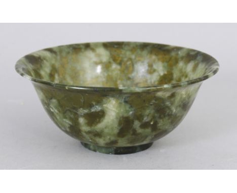 A 20TH CENTURY CHINESE MOTTLED JADE LIKE BOWL, 4in diameter &amp; 1.7in high.