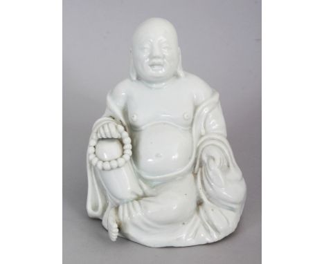 A GOOD CHINESE KANGXI PERIOD BLANC-DE-CHINE PORCELAIN FIGURE OF BUDAI, seated with exposed belly and holding a string of bead