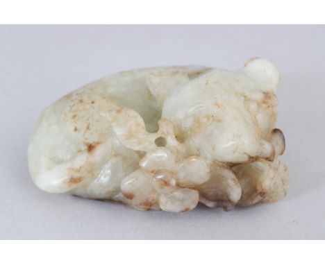 A 19TH/20TH CENTURY CHINESE CELADON JADE CARVING OF A RECUMBENT ANIMAL, clasping a floral sprig in its mouth, 2.2in wide &amp