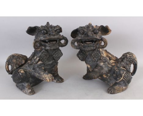 A PAIR OF BLACK PIGMENTED CERAMIC MODELS &amp; COVERS OF BUDDHISTIC LIONS, each with a four-character Xuande mark, 12.5in hig