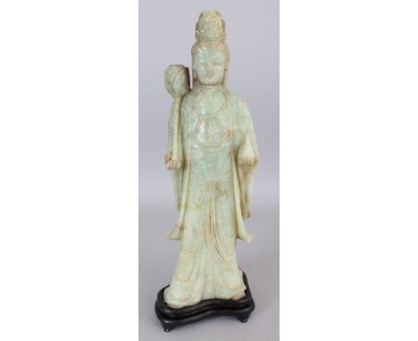 A LARGE 20TH CENTURY CHINESE CELADON GREEN JADE FIGURE OF A STANDING GUANYIN, together with a fitted wood stand, 16.5in high 
