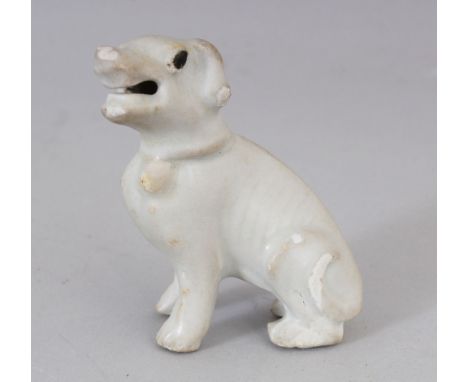 A SMALL CHINESE KANGXI PERIOD PORCELAIN MODEL OF A SEATED HOUND, applied with a pale celadon glaze, 2.75in high.