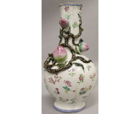 A CHINESE FAMILLE ROSE MOULDED PORCELAIN VASE, the trefoil section body decorated with loose floral sprays, the neck moulded 