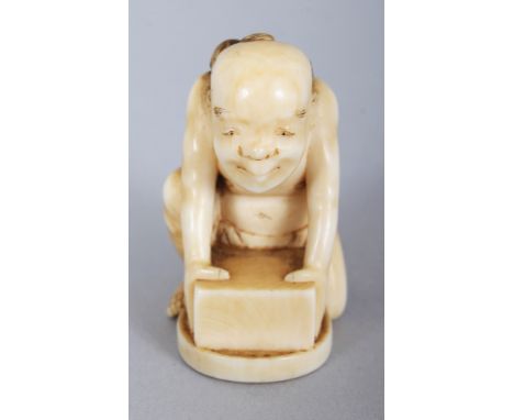 A SIGNED JAPANESE MEIJI PERIOD IVORY NETSUKE OF A KNEELING MAN CLAD IN A LOIN CLOTH, possibly a rat catcher, leaning forward 