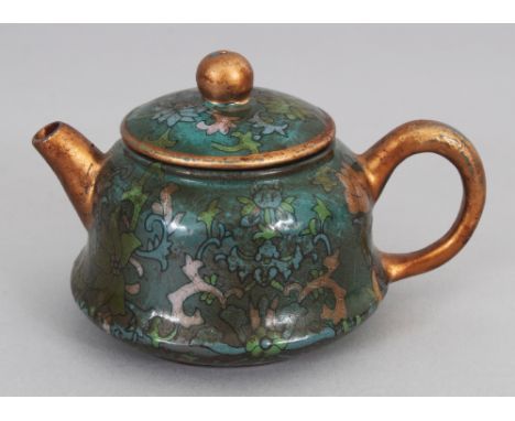 A VERY UNUSUAL SMALL 19TH/20TH CENTURY CHINESE GLAZED YIXING POTTERY TEAPOT &amp; COVER, the sides decorated with foliage and