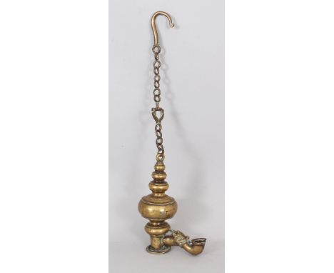 A Brass Hanging Temple Lamp, Burma, 18th/19th century, of segmented bottle shaped form, with projecting makara burner, hook a