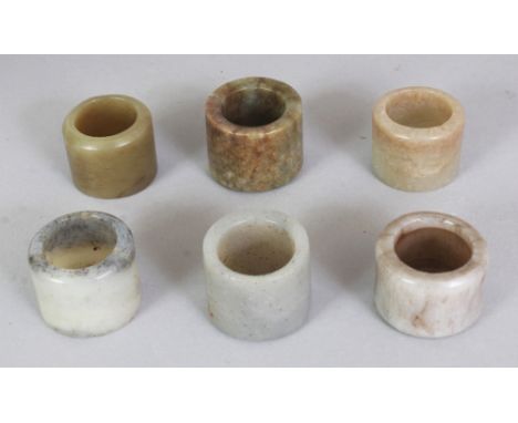A GOOD GROUP OF SIX CHINESE MING &amp; QING DYNASTY JADE ARCHER’S RINGS, slightly different sizes, the largest one 1.25in dia