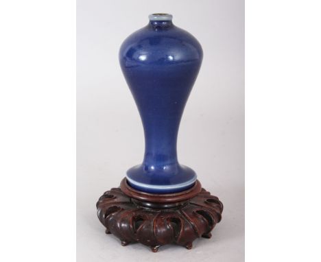 A SMALL CHINESE KANGXI PERIOD BLUE GLAZED PORCELAIN MEIPING VASE, on a splayed foot, together with a fitted wood stand, 6.25i