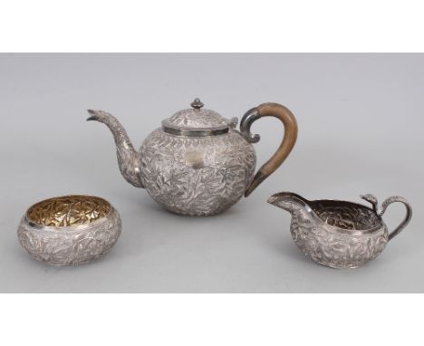 A GOOD 19TH CENTURY INDIAN SILVER-METAL TEA SET, weighing approx. 995gm in total, comprising a teapot with hinged cover, a mi