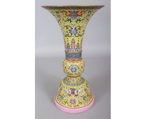 A GOOD QUALITY CHINESE FAMILLE ROSE YELLOW GROUND PORCELAIN GU VASE, the sectional vase with a detachable neck, the sides dec