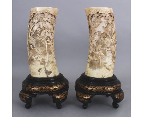 A PAIR OF FINE QUALITY SIGNED JAPANESE MEIJI PERIOD IVORY TUSK VASES, on fixed lacquered wood stands, each vase carved in dee