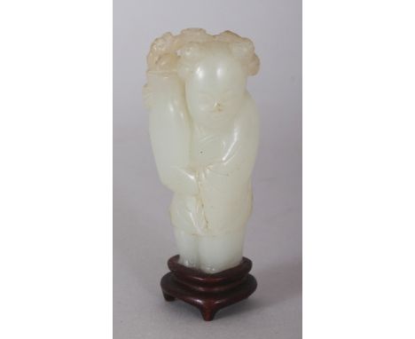 A SMALL 18TH/19TH CENTURY CHINESE CELADON JADE FIGURE OF A STANDING BOY, together with a fixed wood stand, the boy bearing a 