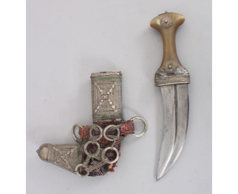 A South Arabian Dagger (Khanjar), early 20th century, with curved ridged blade, horn and white metal hilt and white metal mou