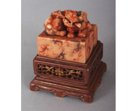 AN UNUSUAL CHINESE IMITATION STONE PORCELAIN SEAL, together with a fitted imitation wood porcelain stand, the square-section 