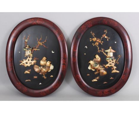 A PAIR OF JAPANESE MEIJI PERIOD MOTHER-OF-PEARL &amp; BONE ONLAID LACQUERED WOOD OVAL HANGING PANELS, each decorated in high 