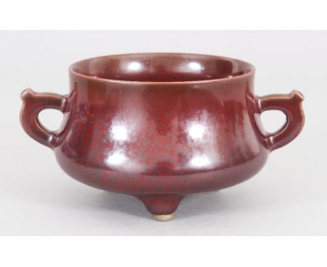 A CHINESE IRON RUST PORCELAIN TRIPOD CENSER, the base with a moulded Qianlong seal mark, 6.7in wide including handles &amp; 4