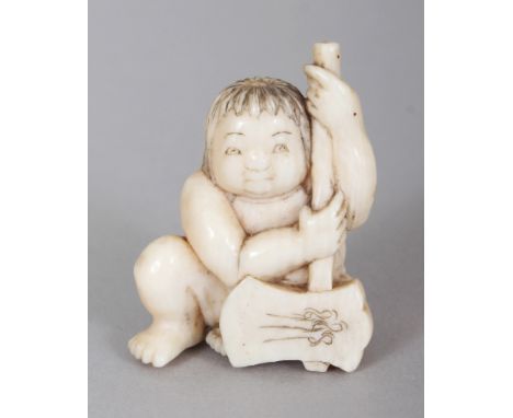 A SIGNED JAPANESE MEIJI PERIOD IVORY NETSUKE OF A SQUATTING BOY HOLDING AN AXE, the base with an engraved signature, 1.3in hi