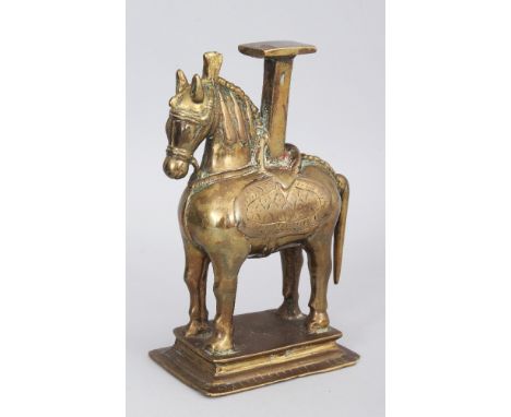 A Temple Lampstand, Northern India, 19th century, in the form of a horse, on rectangular base, the saddle and collar with tra