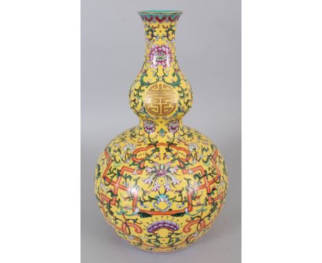 A LARGE CHINESE YELLOW GROUND FAMILLE ROSE PORCELAIN VASE, decorated with linked wan and with formal foliage reserved on a sg