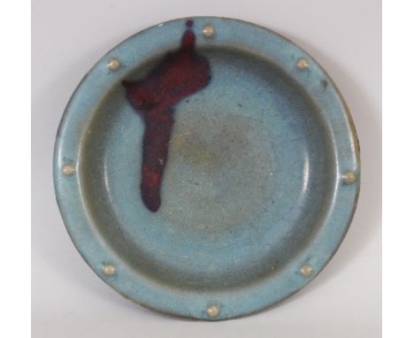 A CHINESE SONG STYLE RU WARE PURPLE SPLASH CERAMIC BOWL, the everted rim with moulded studs, the base unglazed, 9.4in diamete