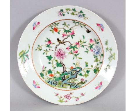 A CHINESE FAMILLE ROSE PORCELAIN PLATE, with a flanged rim, decorated with birds and overhanging peach branches above flowers