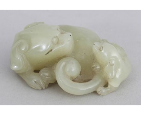 A 19TH/20TH CENTURY CHINESE CELADON JADE MODEL OF A LION DOG &amp; ITS CUB, 2in wide.