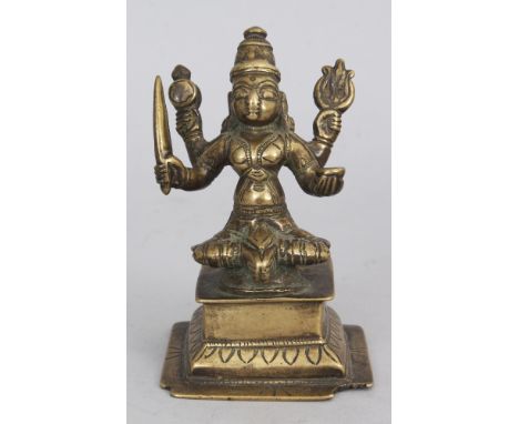 A Brass Figure of Durga, Western Deccan, India, circa 18th century, seated on a raised plinth, the four armed goddess holding