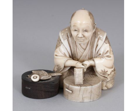 A SIGNED JAPANESE MEIJI PERIOD SECTIONAL IVORY &amp; WOOD OKIMONO OF A SEATED ARTISAN, holding a chisel, his pipe and pouch b