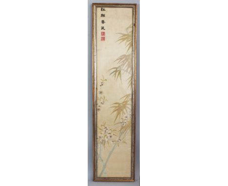 A 19TH/20TH CENTURY FRAMED CHINESE CREAM GROUND EMBROIDERED SILK PANEL, decorated with bamboo and blossom beneath calligraphy