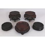 A PAIR OF GOOD QUALITY CHINESE CARVED & PIERCED HARDWOOD VASE STANDS, to support vases with a foot