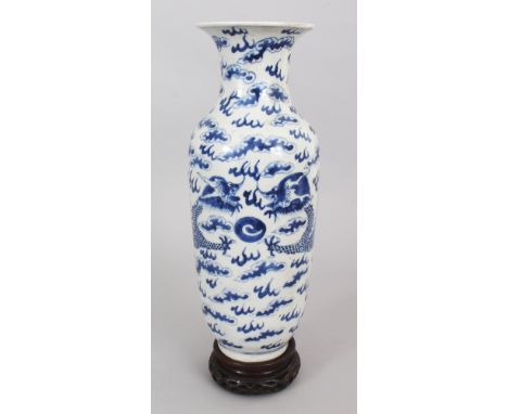 A 19TH CENTURY BLUE &amp; WHITE PORCELAIN DRAGON VASE, together with a fitted wood stand, the base with a four-character Kang