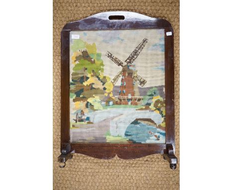 A mahogany fire screen with embroidered insert