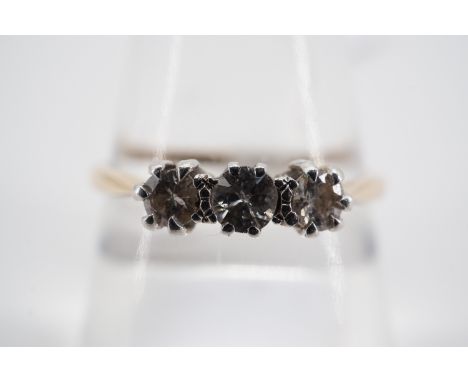 A vintage three stone brilliant-cut diamond ring, each of approximately .10ct, pellet and crown set on a reverse tapering hig