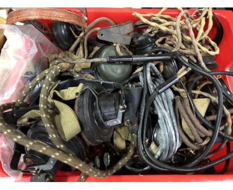 A large quantity of British army headphones, microphones etc