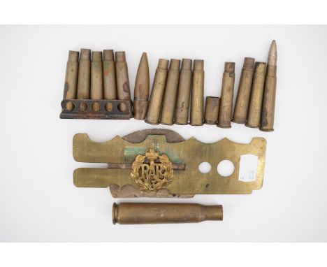 An RAF cap badge, brass button stick and sundry inert cartridge cases etc
