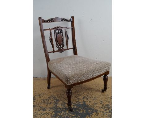 A Victorian marquetry inlaid nursing chair