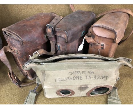 Three US Army field telephones together with a post-War example in webbing case