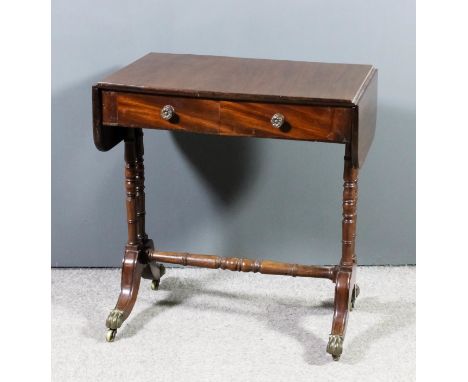 A mahogany sofa table of 18th Century design, fitted two real and two dummy frieze drawers, on twin turned end supports, with