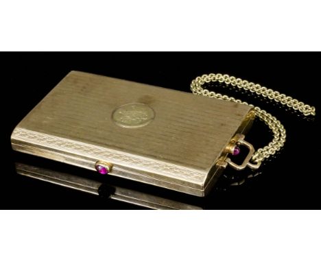 An early 20th Century lady's 14k gold and ruby set compact, with engine turned decoration and three thumb pieces each set wit